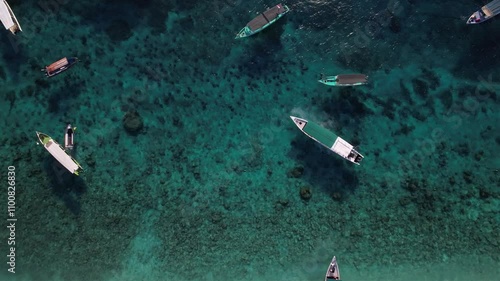 view of the beautiful blue sea water from above. drone view over the clear ocean with boats around it