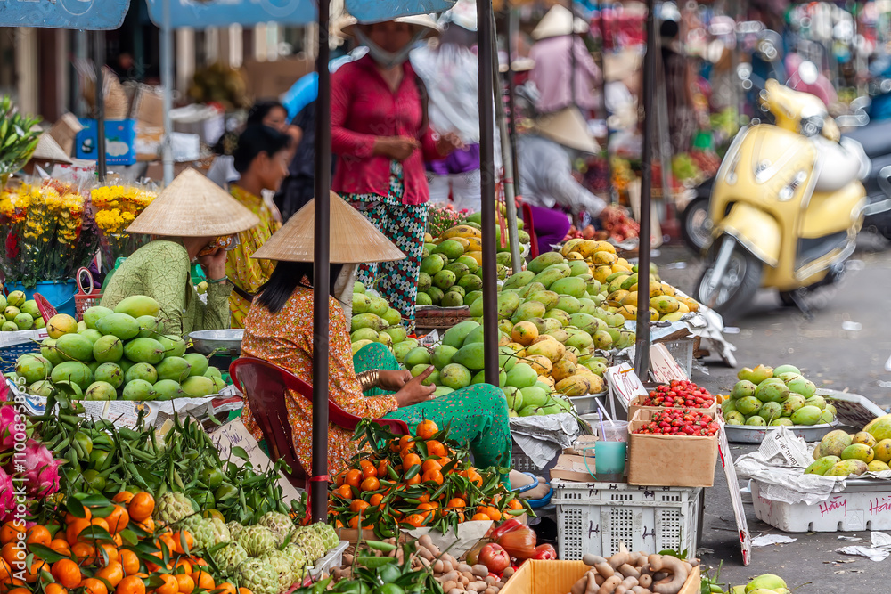 Fruit vendors on Cholon Market, Ho Chi Minh City, Vietnam - Blurred background