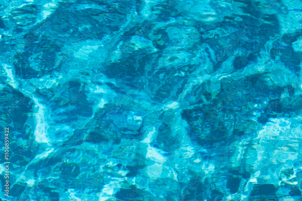 Obraz premium Blue pool water background. Blurred transparent clear calm water surface texture. Water waves in sunlight with copy space.