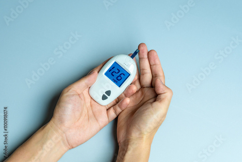 woman's hands checking diabetes and hyperglycemia with digital blood sugar meter. Healthcare and medical concept