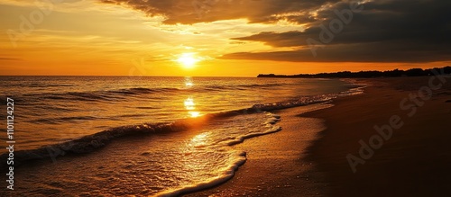 Serene Golden Sunset Reflecting on Tranquil Shore with Gentle Waves and Dramatic Cloudscape photo