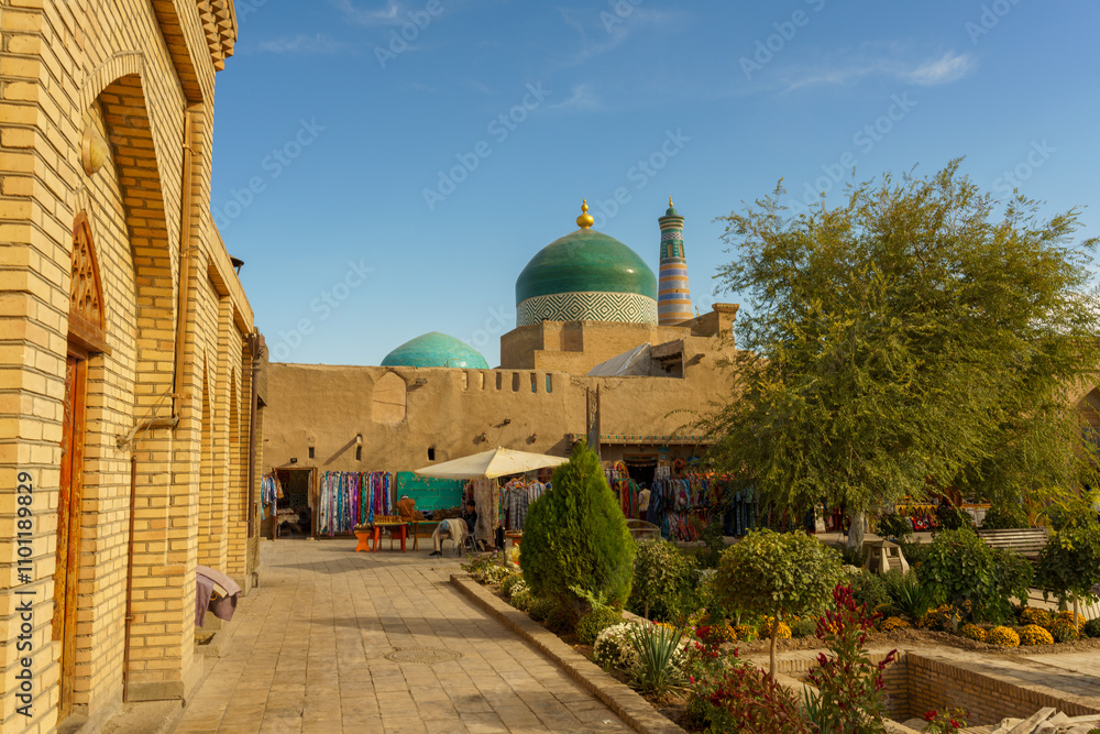 Fototapeta premium A brick building with a green dome and a white umbrella