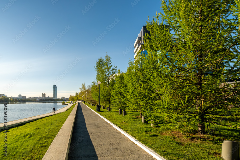 Fototapeta premium A road on the river embankment for walking on a summer day.