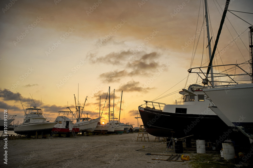 Fototapeta premium The marina is filled with various boats resting on dry land.