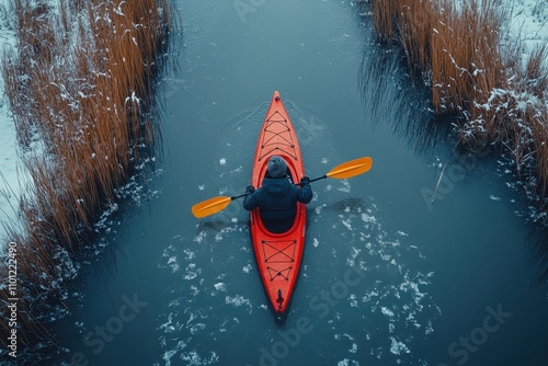 Aerial View of a Kayaker in a Red Kayak on a Frozen Lake