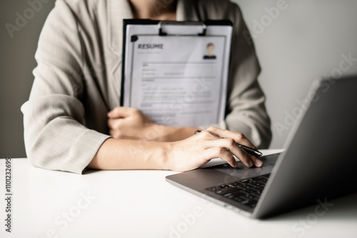 Business woman employer holding resume hiring recruit looking cv resume to hire candidates, analyzing information before job interview. Recruitment concepts photo