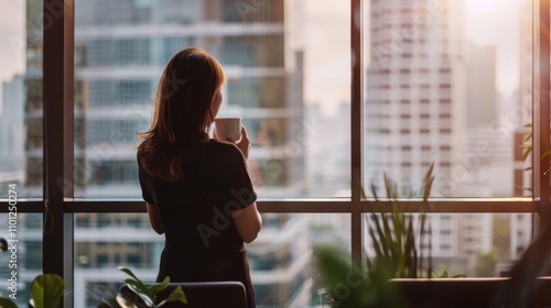 A businesswoman standing at a large window in a high-rise office, looking out at the city skyline, She is holding a cup of coffee and appears to be deep in thought