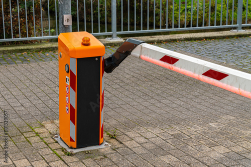 Automatic barrier at a secure parking entrance during the day