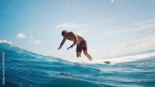 Surfer rides the wave in the Maldives