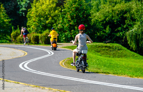 Wallpaper Mural A woman rolls on an electric scooter in the Park
 Torontodigital.ca