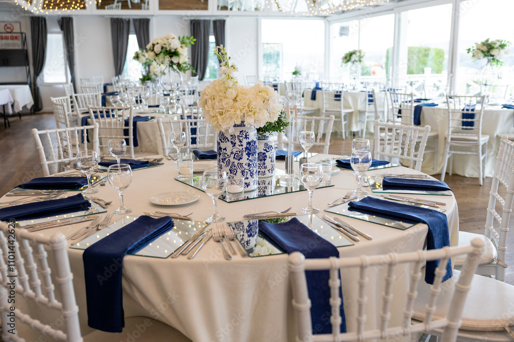 Minimalist wedding table decor with white flowers and navy blue accents
