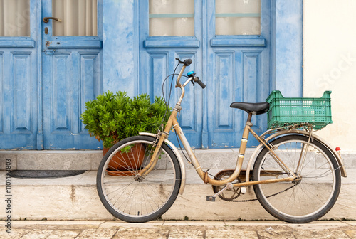 Lonely bicycle with shopping basket on the street in Greece photo