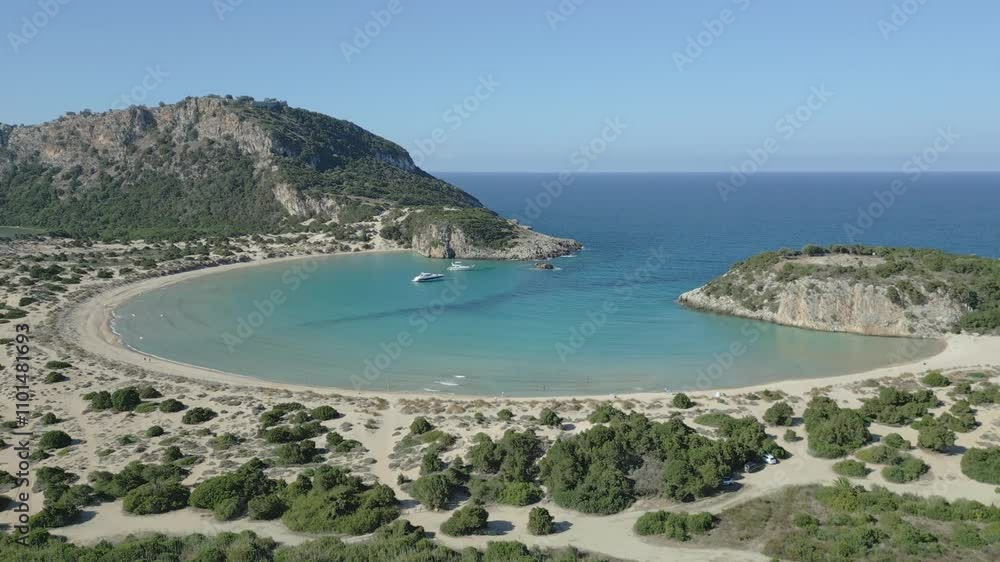 An aerial view of Voidokilia Beach as the drone ascends higher An aerial view of Voidokilia Beach as the drone ascends higher