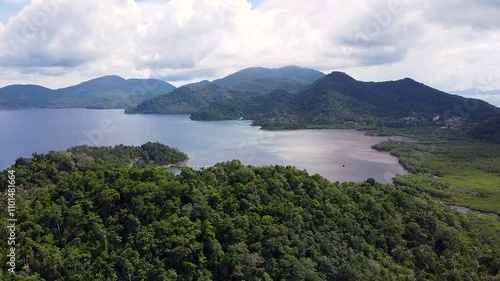 Scenic aerial view rising over tropical island of Pulau Weh with forest trees, mangroves on coastline and volcanic mountainous landscape in Aceh, Sumatra, Indonesia