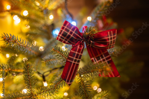 Season's greetings scene. Christmas decorations, balls, rustic star, holly berries, frosty spruce branches, confetti, blur lights on green backdrop, perfect for messages or promo