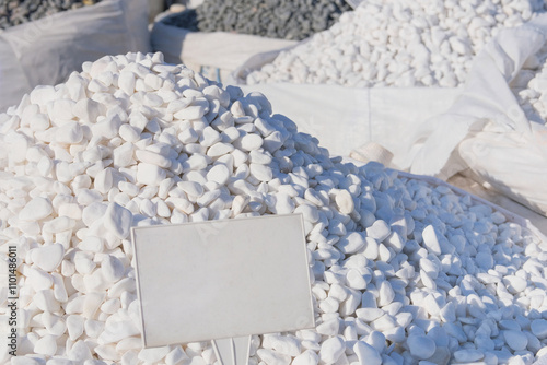 Dolomite mineral stones are sold in construction market. Close up of materials pile. White materials for decoration and construction. Place for text. photo