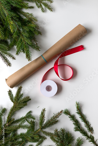 wrapping Christmas gifts in craft paper and red ribbon