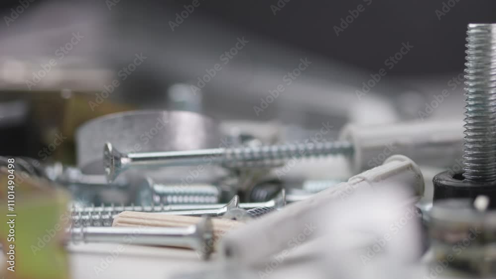 A detailed view of screws, hinges, and assembly dowels, captured with a macro lens as the camera smoothly pans across the hardware components. A detailed view of screws, hinges, and assembly dowels, captured with a macro lens as the camera smoothly pans across the hardware components.