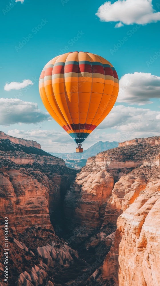 Obraz premium Hot Air Balloon Rising Over Scenic Valley Landscape