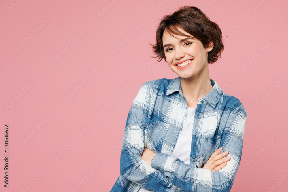Young smiling happy cheerful woman wear blue shirt white t-shirt casual clothes hold hands crossed folded look camera isolated on plain pastel light pink background studio portrait. Lifestyle concept. Young smiling happy cheerful woman wear blue shirt white t-shirt casual clothes hold hands crossed folded look camera isolated on plain pastel light pink background studio portrait. Lifestyle concept.