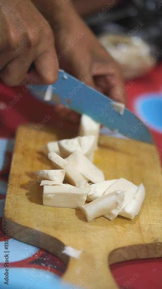 Cassava is cut with a kitchen knife, peeled and looks clean and white. Cassava is cut with a kitchen knife, peeled and looks clean and white.