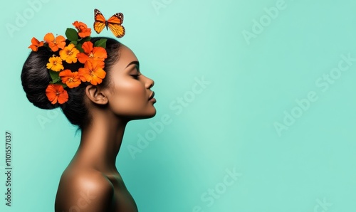 Silhouette of woman's profile with vibrant flowers and butterflies on soft blue-green background in pastel colors  photo