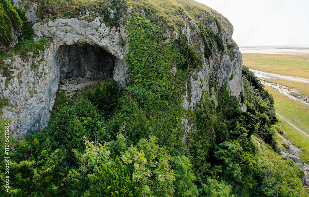 Fairy Chapel Cave on west side of Humphrey Head limestone outcrop. View SE over tidal mudflats of Morecombe Bay Morecombe Sands. Prehistoric site