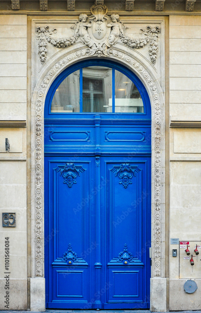 Naklejka premium Parisian Craftsmanship: The Refined Elegance of Urban Wooden Doors (in blue color), France, Europe