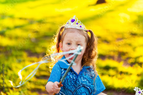 Aboriginal kamilaroi girl with princess wand and tiara playing in backyard photo