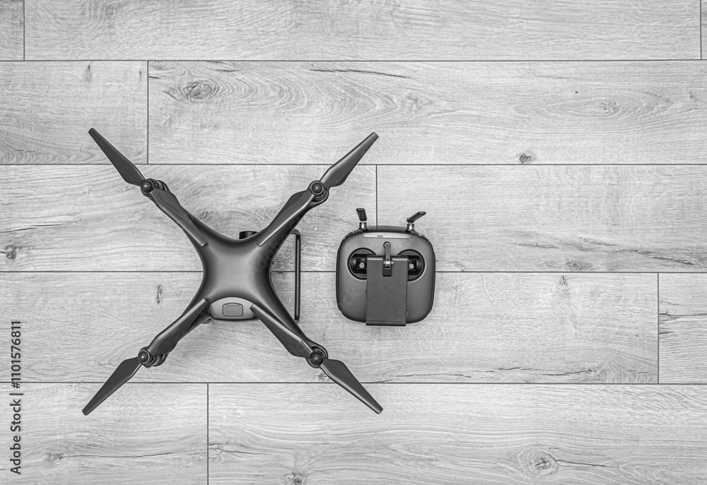 Dark drone on wooden background. Monochrome shot.