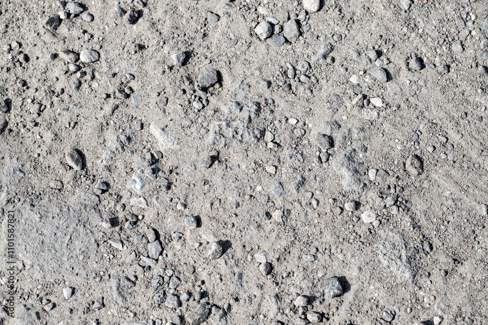 A rocky, gray surface with a few large rocks scattered throughout A rocky, gray surface with a few large rocks scattered throughout