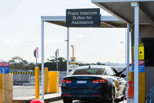 Vehicle exiting car park paying for parking at booth photo