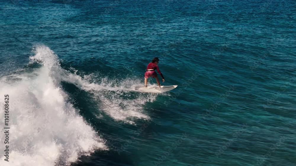 Teen boy surfer rides the wave in the Maldives Teen boy surfer rides the wave in the Maldives