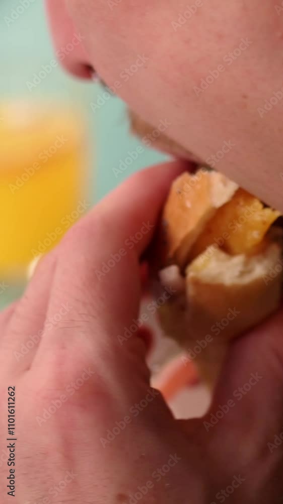 slow motion vertical video of young man biting a hamburger slow motion vertical video of young man biting a hamburger