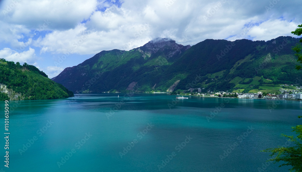 A breathtaking landscape featuring a scenic blue lake with serene mountains in the background, beneath a sky filled with fluffy white clouds and gentle sunlight. A breathtaking landscape featuring a scenic blue lake with serene mountains in the background, beneath a sky filled with fluffy white clouds and gentle sunlight.