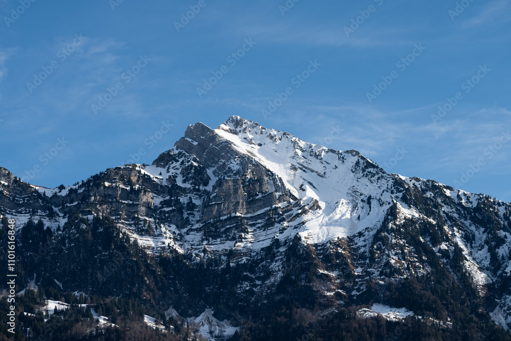 A majestic snow-capped mountain peak rises triumphantly into the clear blue sky, embodying nature’s majestic beauty and the grandeur of the wilderness. A majestic snow-capped mountain peak rises triumphantly into the clear blue sky, embodying nature’s majestic beauty and the grandeur of the wilderness.