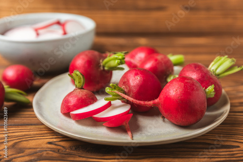 Fresh radish on textured wooden background. Organic natural garden radish slices. clipping root crop. Vegetables. Vegan. Diet products. Healthy food. Place for text. Copy space.