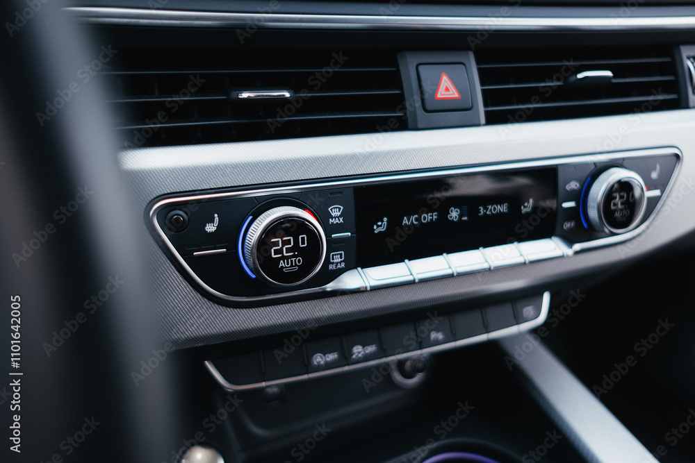 Fototapeta premium Modern brown car interior, leather steering wheel, climate control, navigation, air ducts, deflectors on the car panel, interior details.