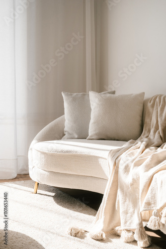 Cozy modern living room with soft sofa and warm sunlight streaming in