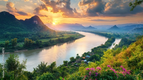 Sunset over the Mekong River in Nong Khai, Thailand, with mountains and green countryside framing the serene waters. The sky is ablaze with warm colors, creating a mesmerizing view.