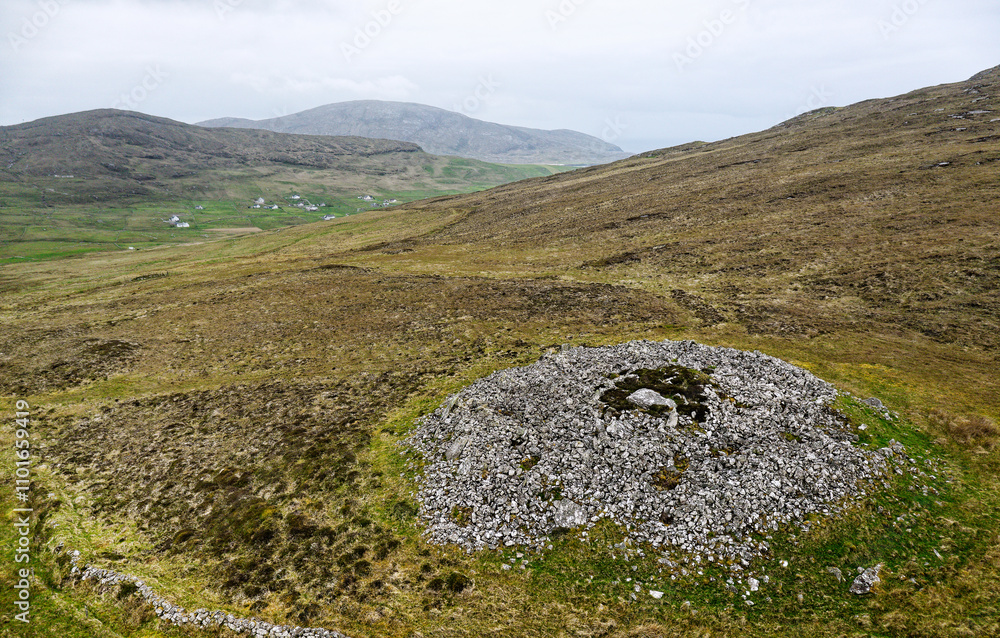Dun Bharpa prehistoric Neolithic chambered cairn with peristalith stone ring at Borve, Barra, Outer Hebrides. Looking SW to Borve