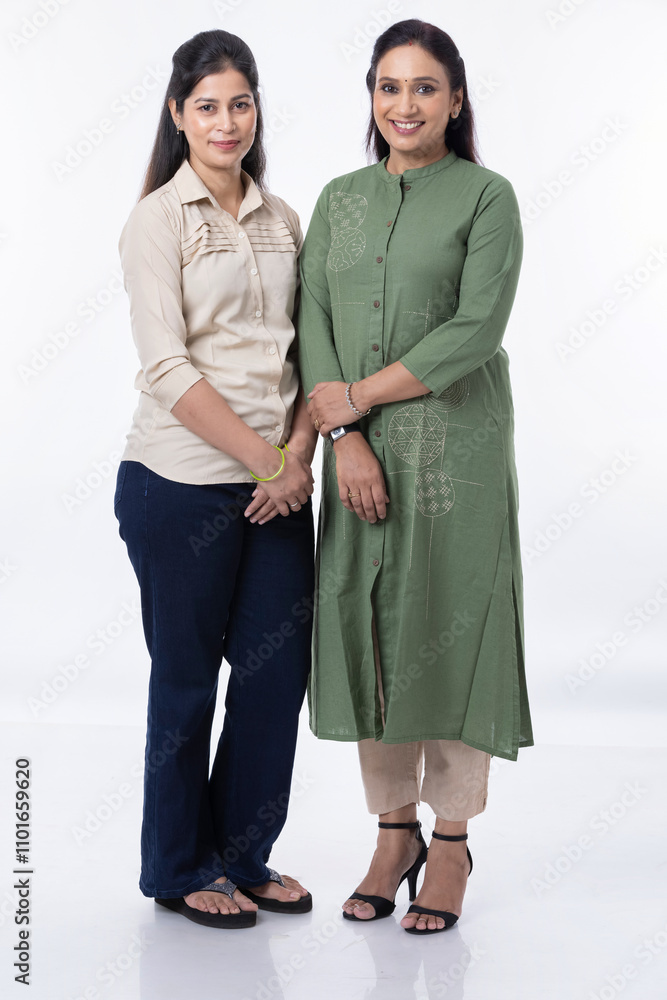 Two Indian woman posing at white background Two Indian woman posing at white background