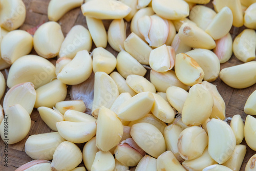 Abstract pattern and shape of pile of peeled Garlic. Garlic for cooking seasoning. Fragrant and fresh aroma. Natural pattern and texture background for graphic design. Related to agricultural and trad photo