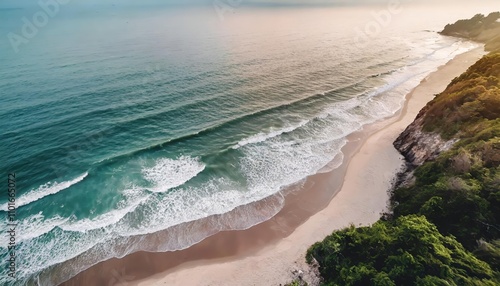 Breathtaking top drone view of a stunning sandy beach bathed in warm sunlight, showcasing tranquil blue sea waters and natural beauty that inspires relaxation and serene coastal vibes.
