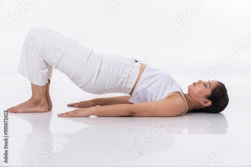 Canvas Print Studio shot of a young fit woman doing yoga exercises white background,