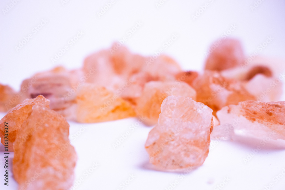 A pile of pink rocks on a white background. The rocks are of different sizes and shapes, and they appear to be arranged in a random pattern. A pile of pink rocks on a white background. The rocks are of different sizes and shapes, and they appear to be arranged in a random pattern.