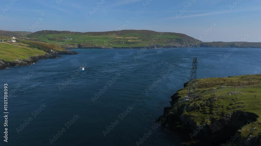 Dursey Island Cable Car, County Cork, Ireland, September 2024. Drone orbits counter clockwise as gondola crosses open deep blue ocean in a sweeping panorama with waves rippling over the ocean surface. Dursey Island Cable Car, County Cork, Ireland, September 2024. Drone orbits counter clockwise as gondola crosses open deep blue ocean in a sweeping panorama with waves rippling over the ocean surface.