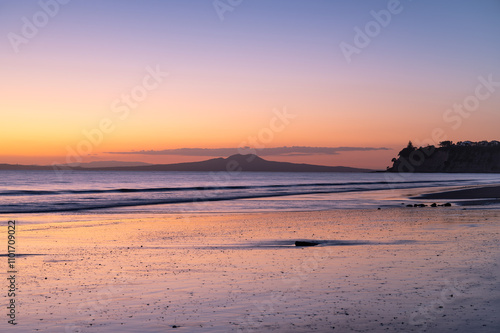 Majestic sunrise over the Rangitoto Island as view from Long Bay, Auckland, New Zealand