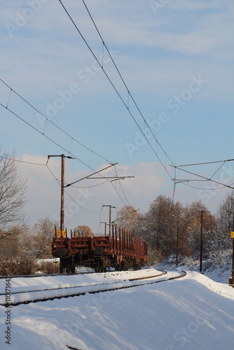 Cargo train on rails in winter with snow