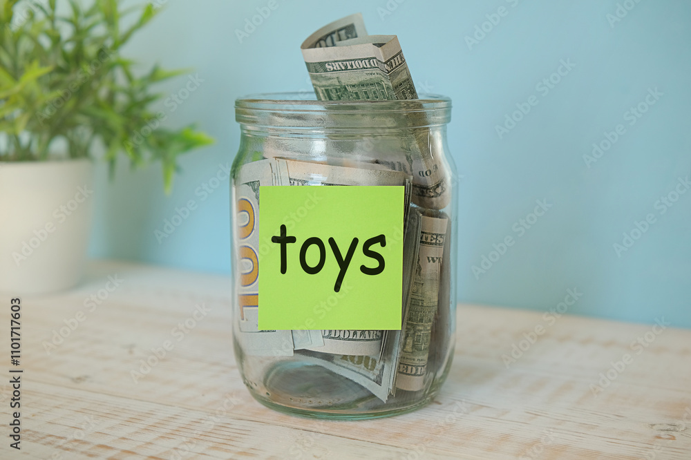 Saving money for Toys jar concept. Money box on empty table collect banknote.